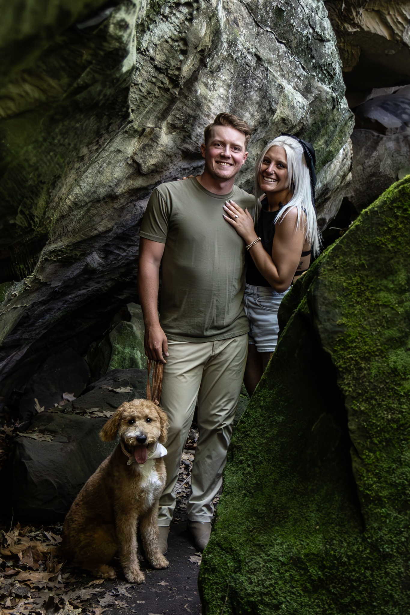 Christian with his partner and their dog outdoors